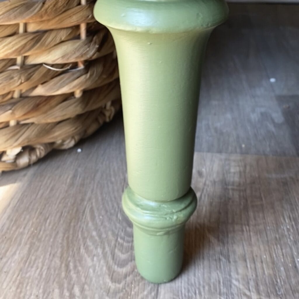 Leg of dresser that has been fixed with a mold and Bondo.
