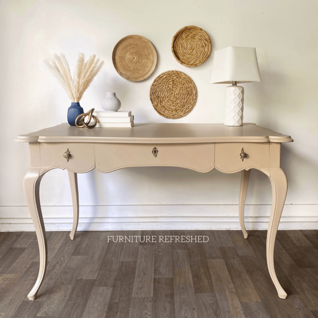 Tan/peach colored painted writing desk.