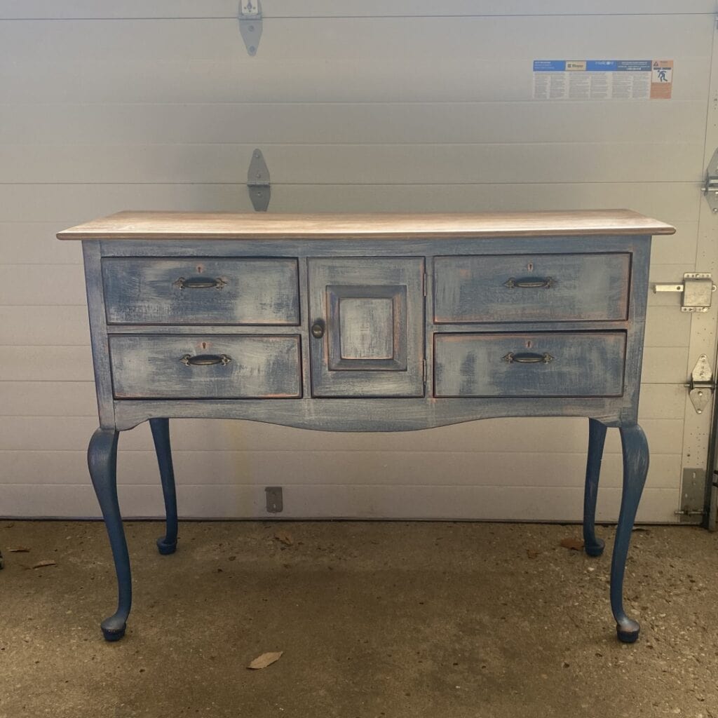 Photo of a buffet with an old paint job. The before photo.