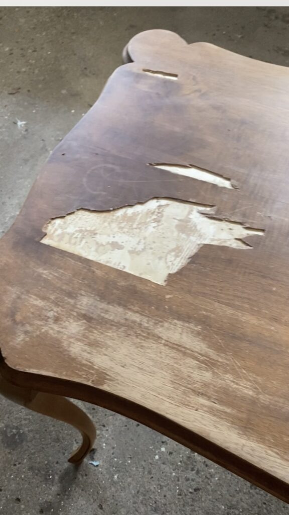A photo of a desktop with missing veneer.