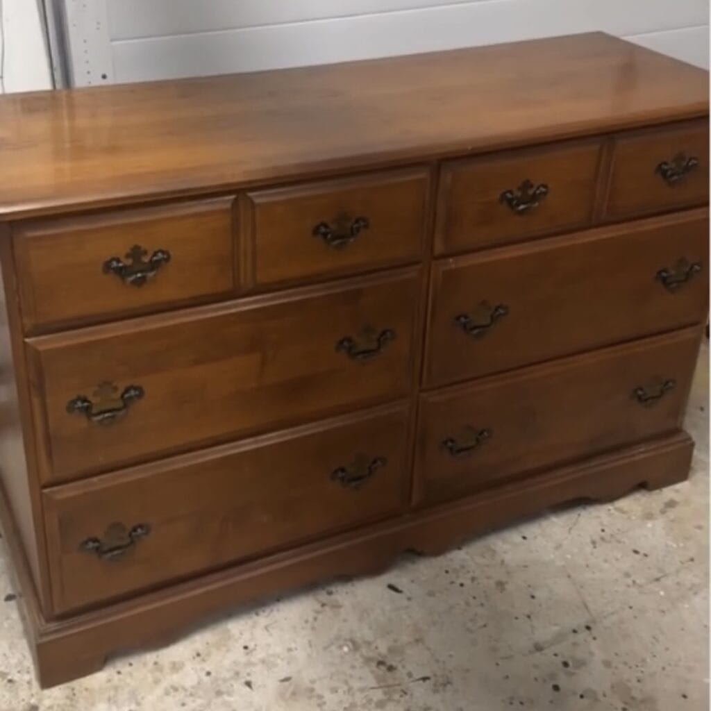 Photo of vintage maple six drawer dresser with dated base and hardware.