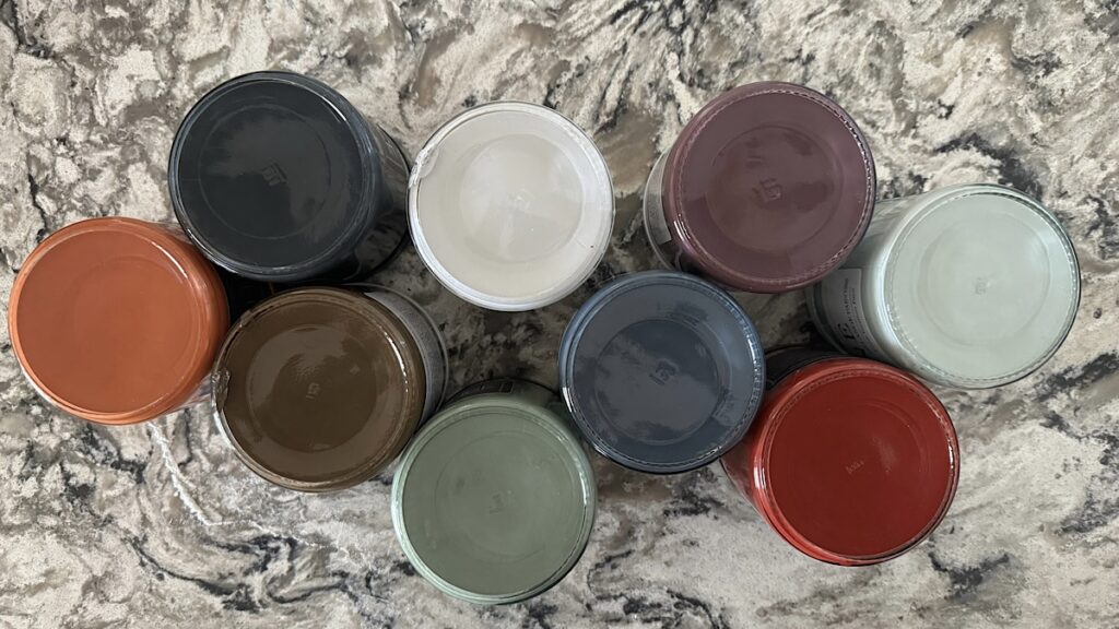 Photo of upside down paint jars showcasing various colors.