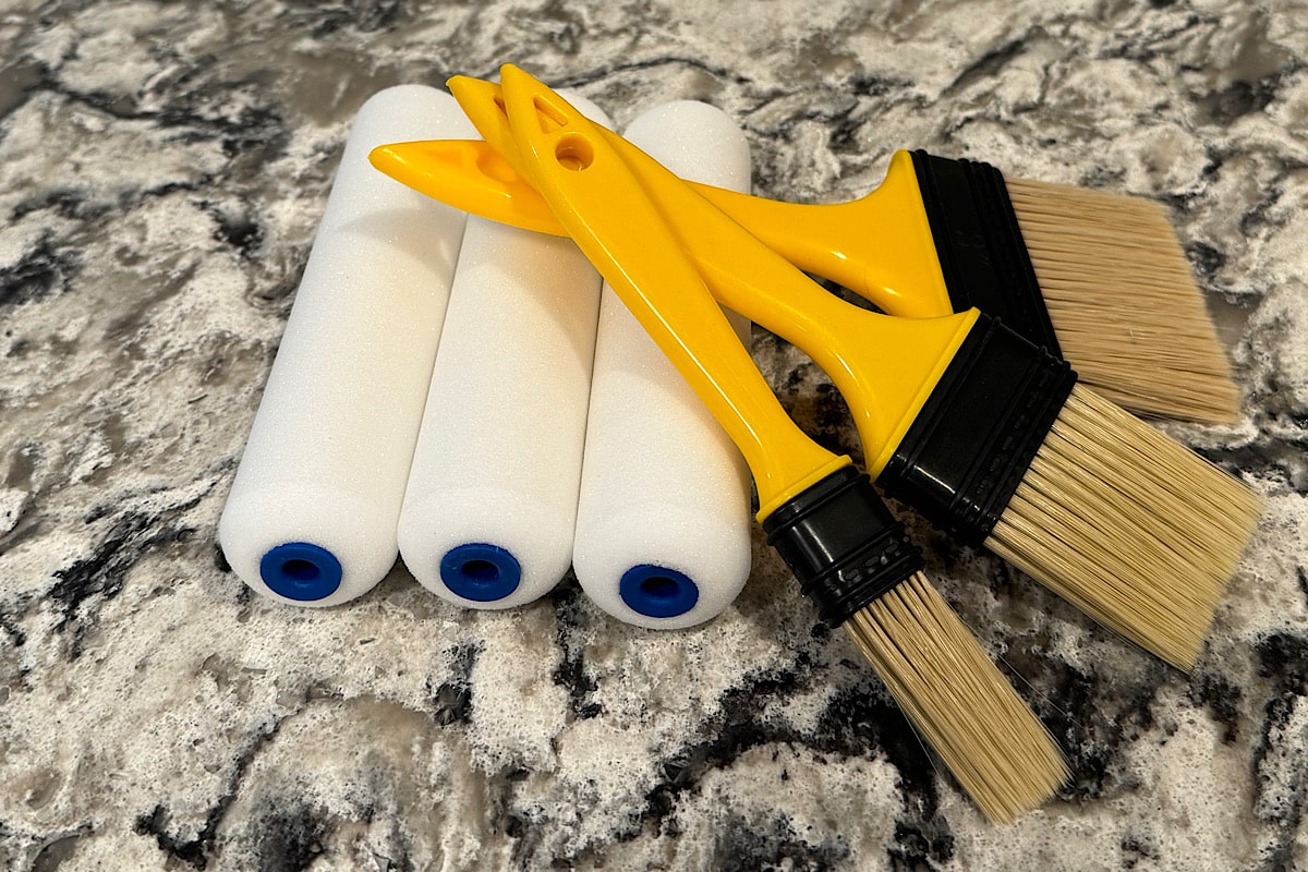 CLose up photo of chip brushes and foam paint rollers for furniture flippers.