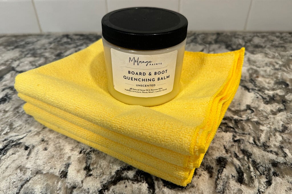 Melange Paints board and boot quenching balm with yellow microfiber cloths.