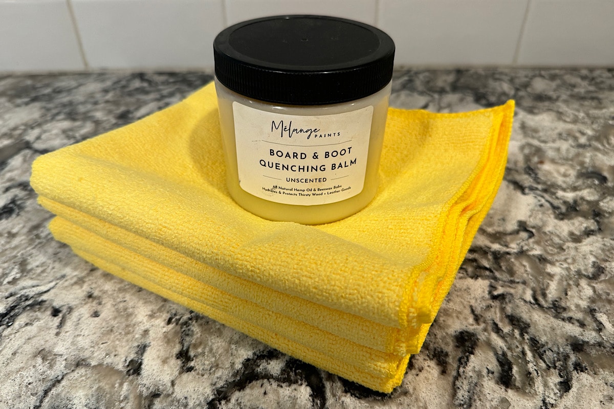 Melange Paints board and boot quenching balm with yellow microfiber cloths.
