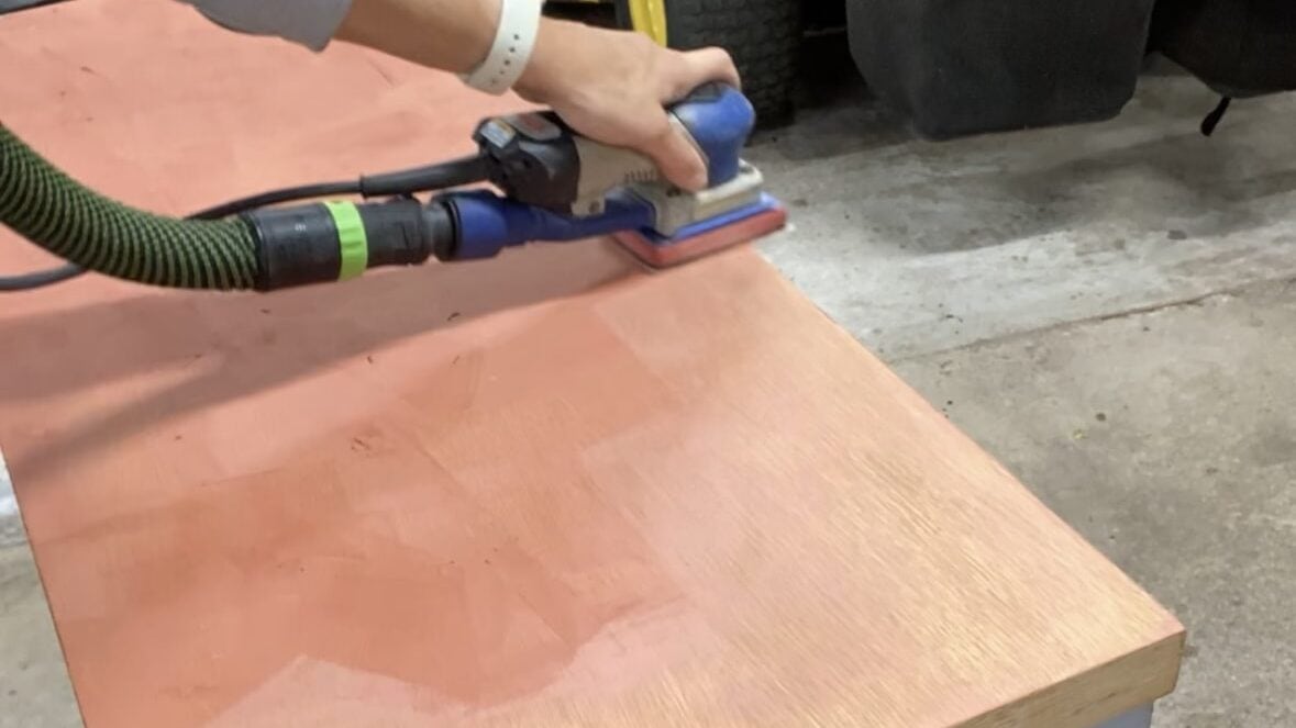 Sanding of Bondo glazing and spot putty after using it to fill scratches in the top of a dresser.