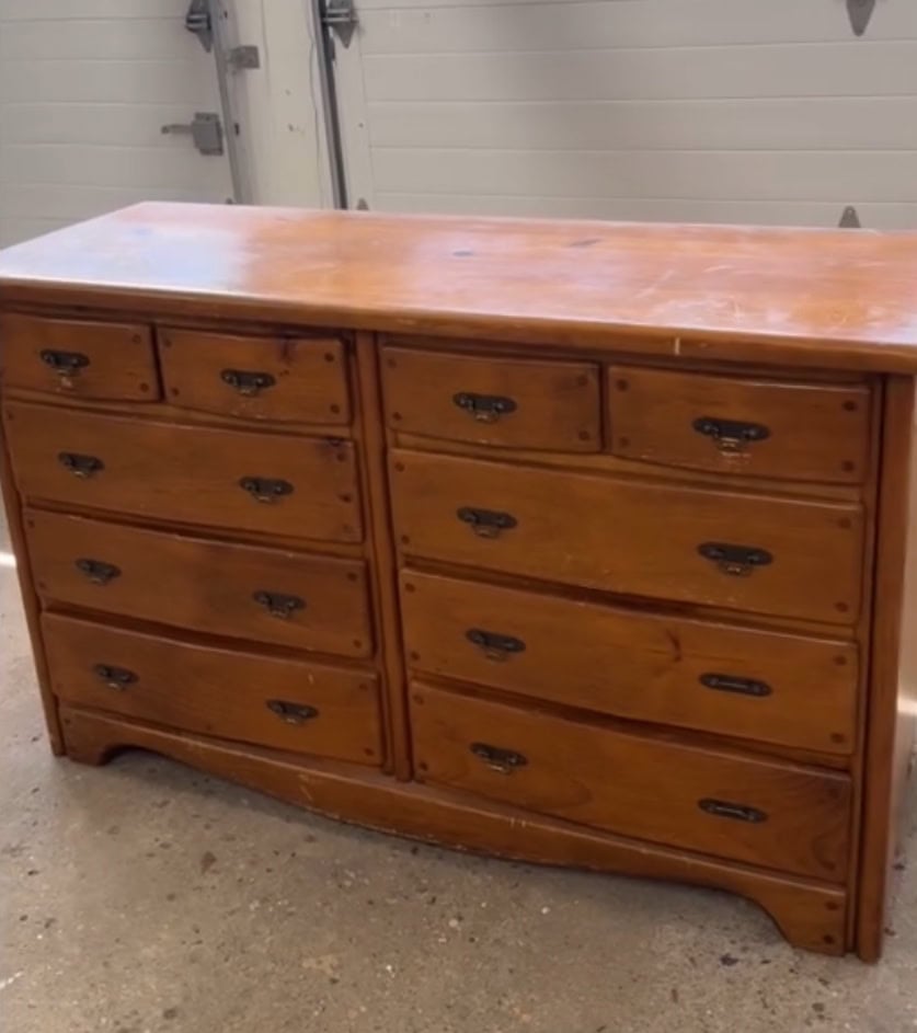 Before photo of pine dresser with dated hardware and lots of knots.