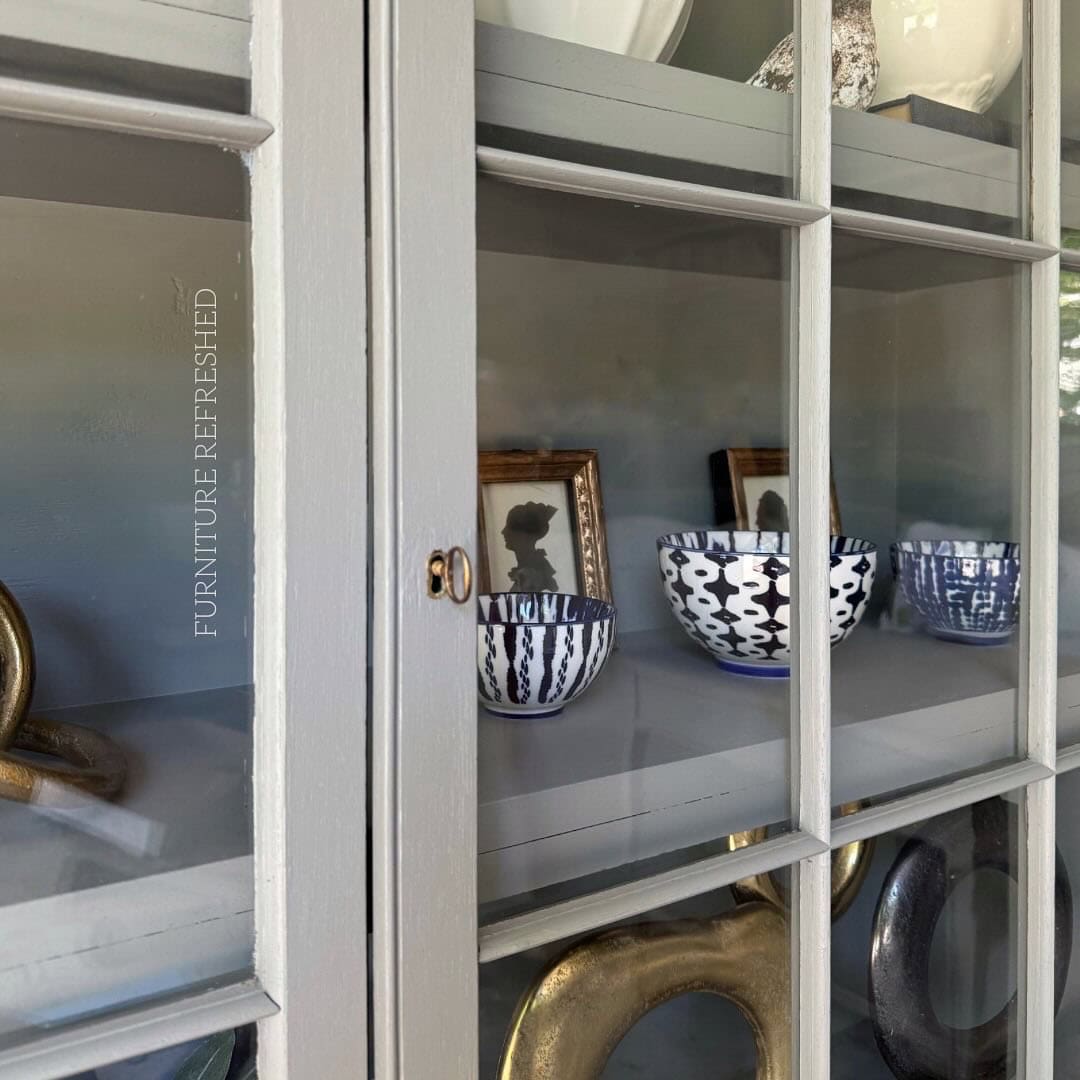 Close up of painted cabinet door glass.