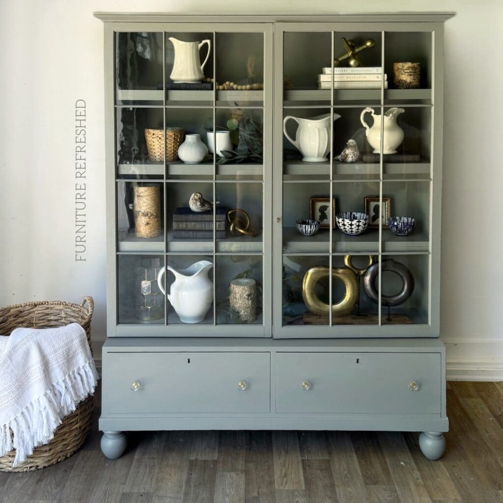 After photo of brown wood cabinet with glass paned doors that was used in this project. Glass was painted around using masking liquid, which is described in this article.