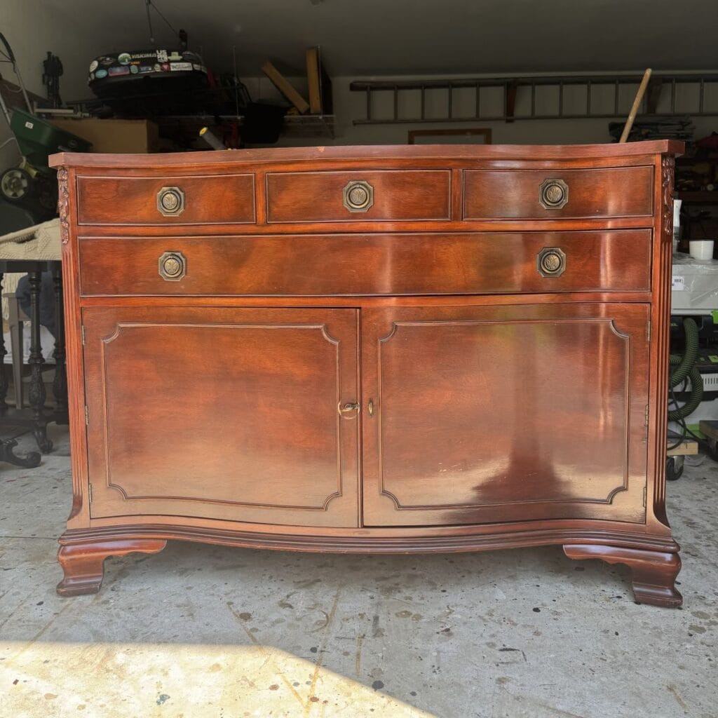 Before photo of black distressed buffet.