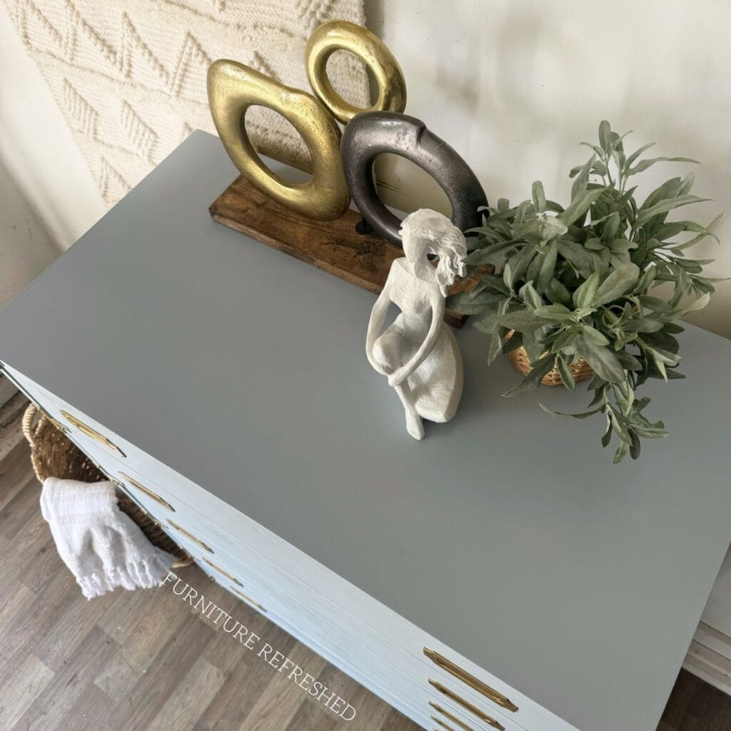 Top view of the laminate painted top of this dresser.