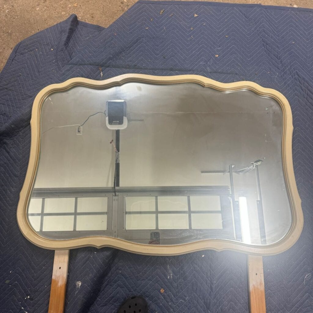 Before photo of a large white French provincial style mirror.