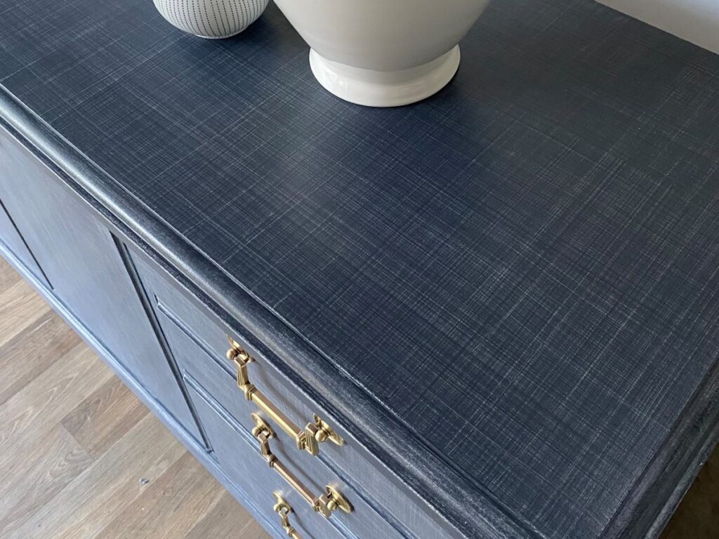 Closeup photo of grasscloth finish in navy. You can see the crosshatch pattern in this closeup.