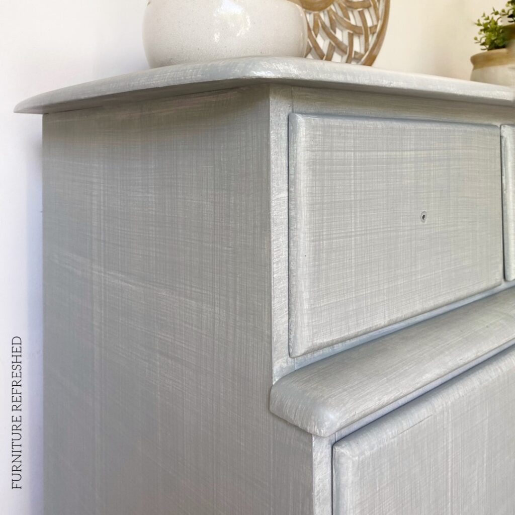 Closeup photo of grasscloth finish in light blue. You can see the crosshatch pattern in this closeup.