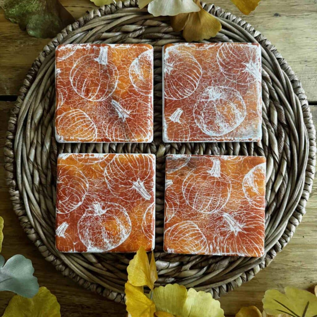 Marble coasters with a pumpkin pattern.