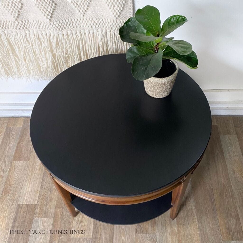 Top view of a painted black round table with a smooth finish