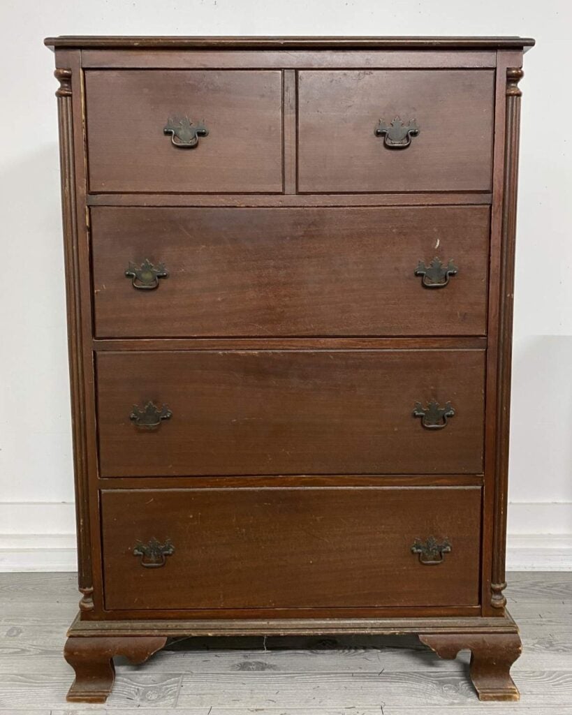 Before photo of a vintage tallboy dresser stained brown.