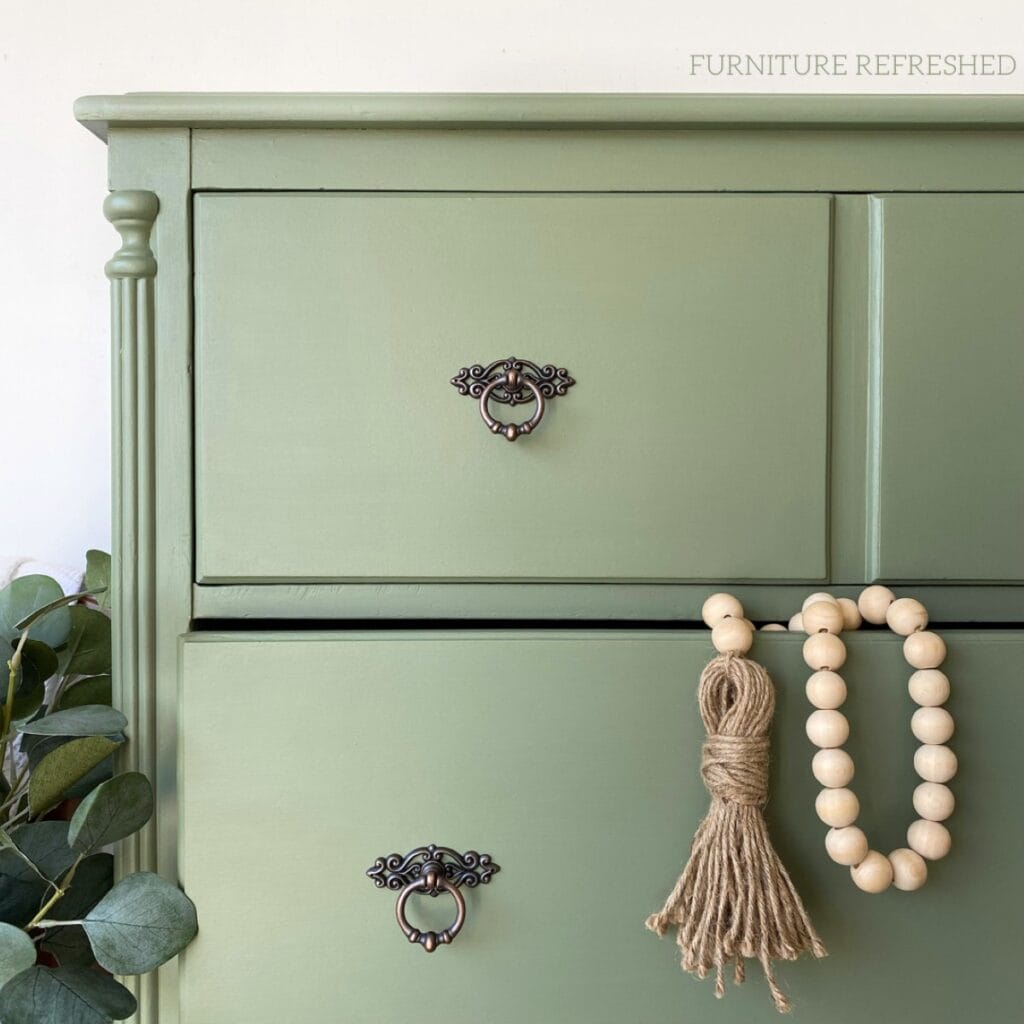 Close of of the top drawer and new hardware on painted sage green dresser