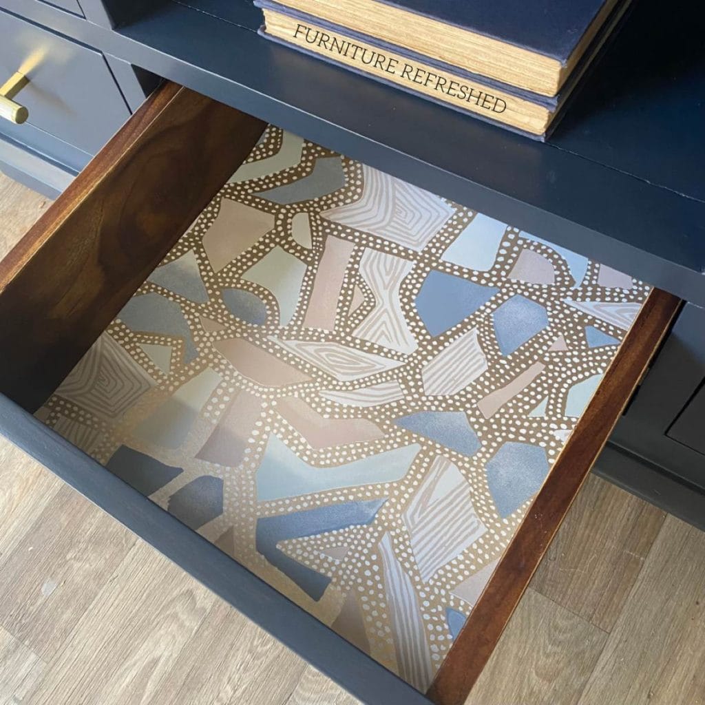 Close of up of the wallpaper drawer liner inside the sideboard