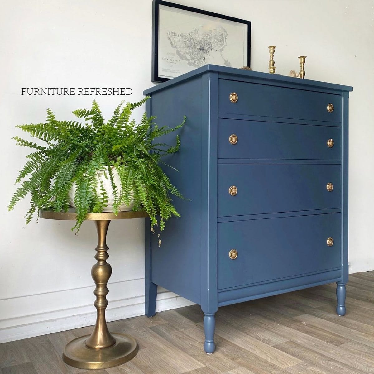 After photo of 4 drawer dresser painted navy blue and updated vintage brass hardware added. photo shows dresser slightly angled.