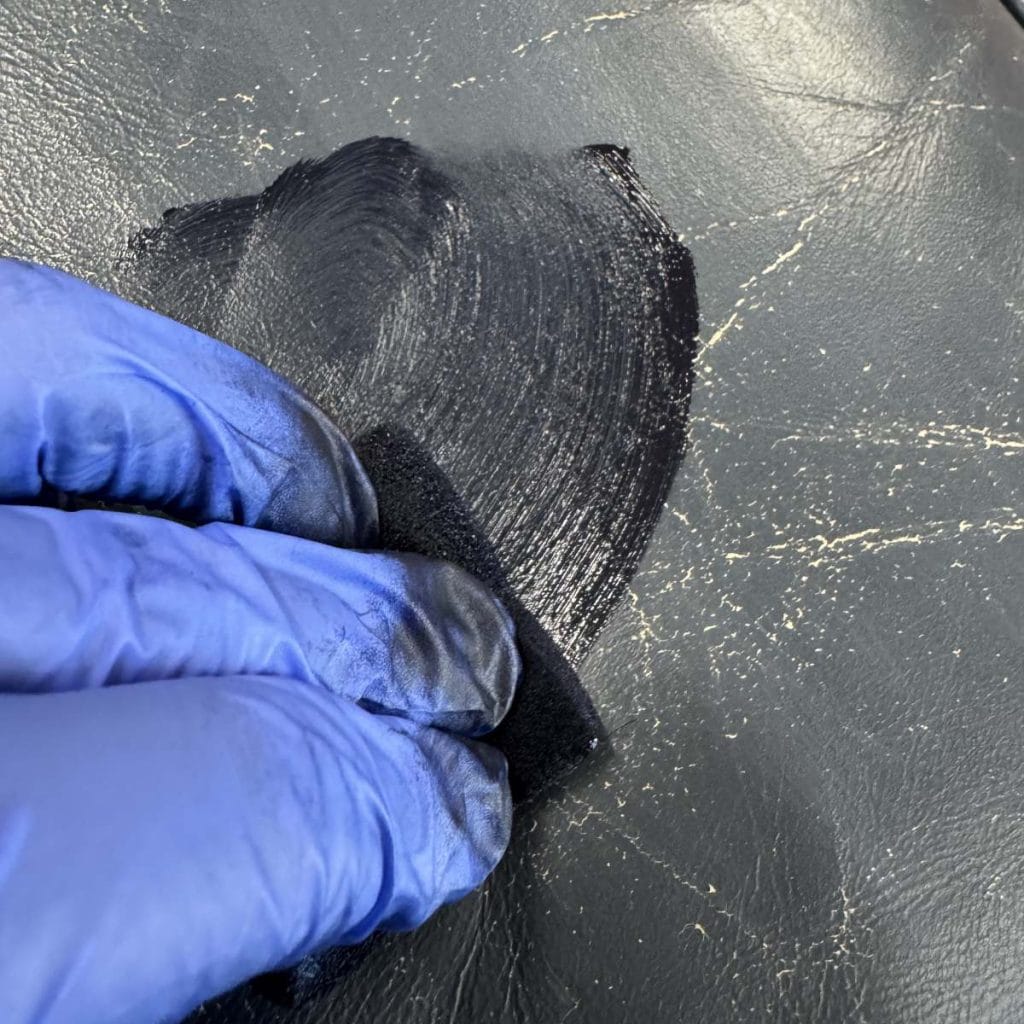 applying the recoloring balm to the leather.