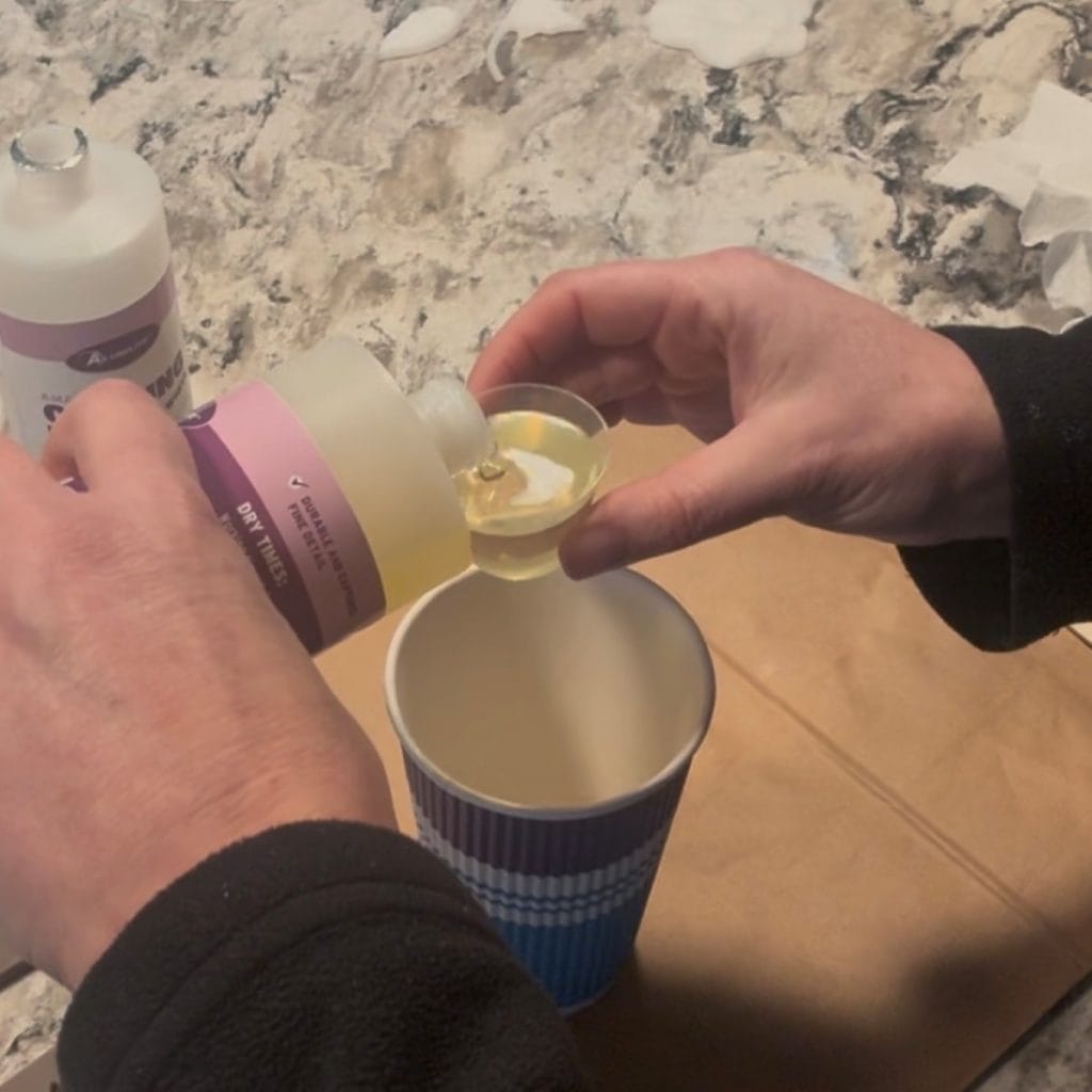 Pouring casting liquid into measuring cup