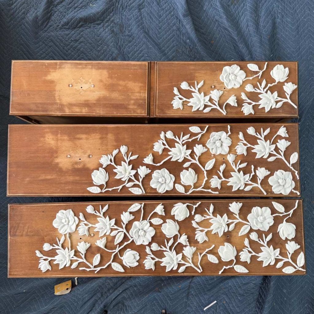 Drawer fronts with appliques placed in their positions.