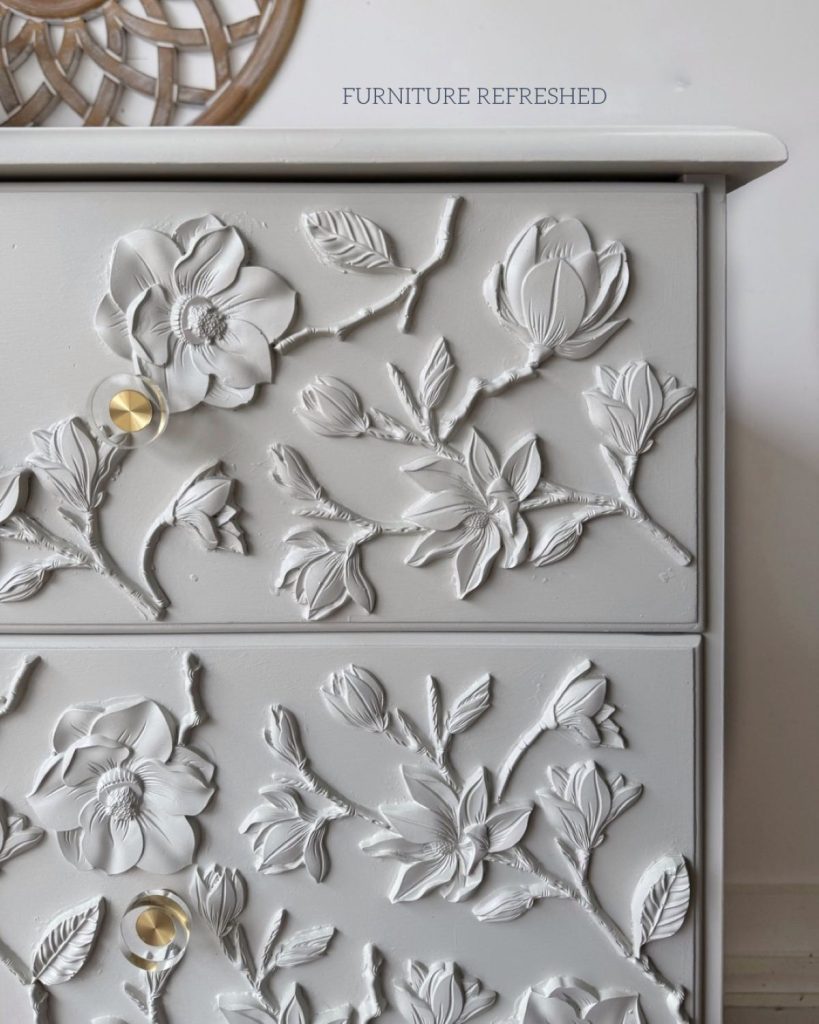 Close up of painted floral appliques and hardware.