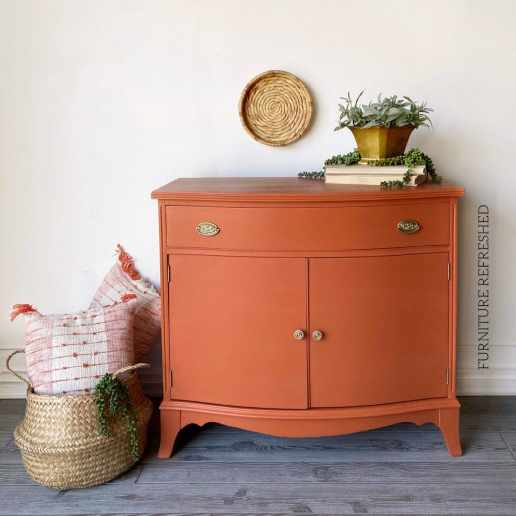After photo of small hepplewhite cabinet painted in coral.