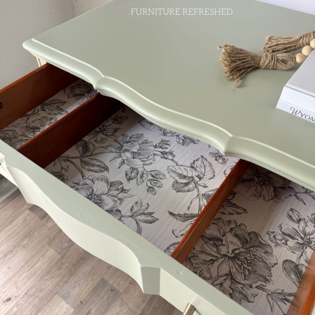Close up of wallpaper lining the inside of the top drawer.