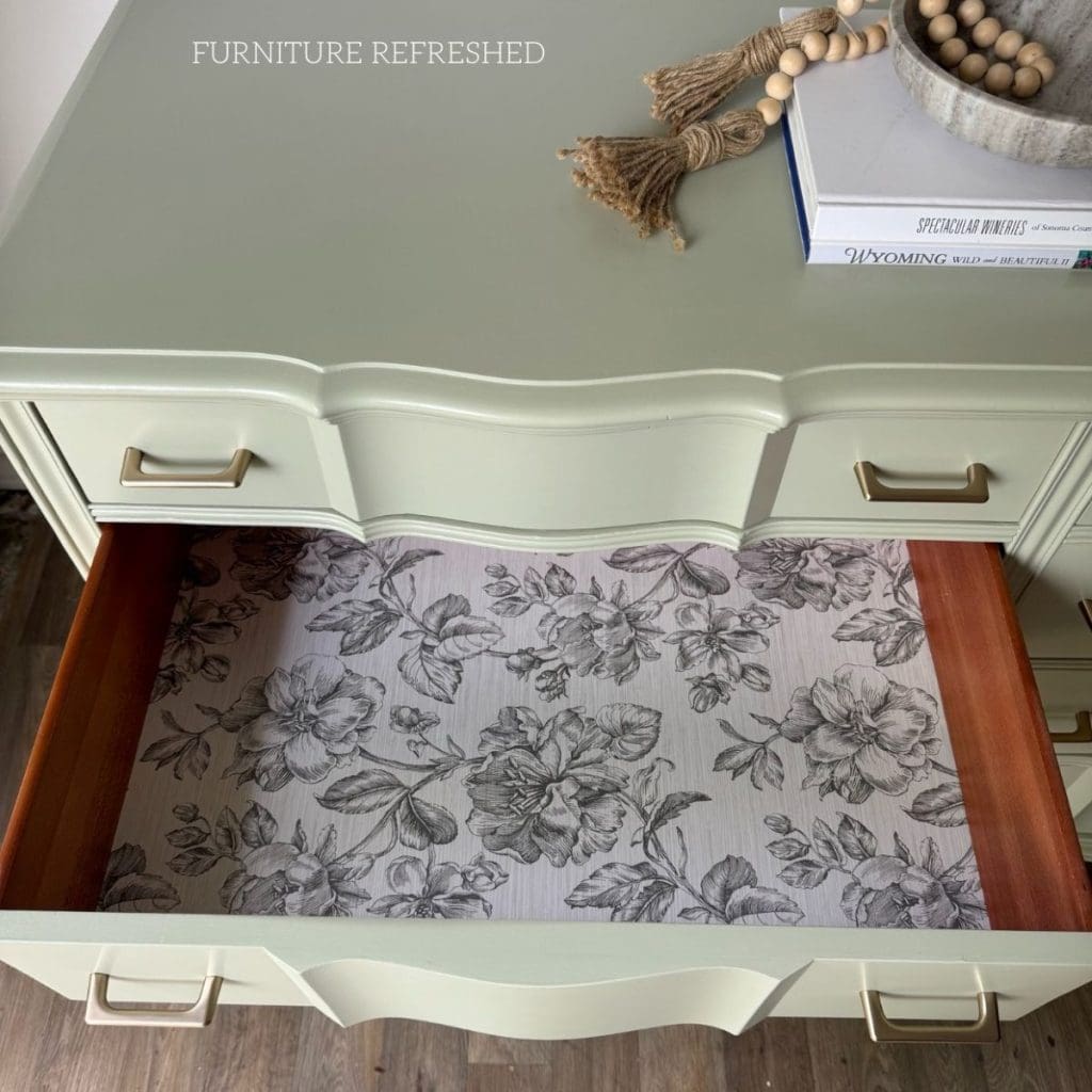 Close up of wallpaper lining the inside of the middle drawer.