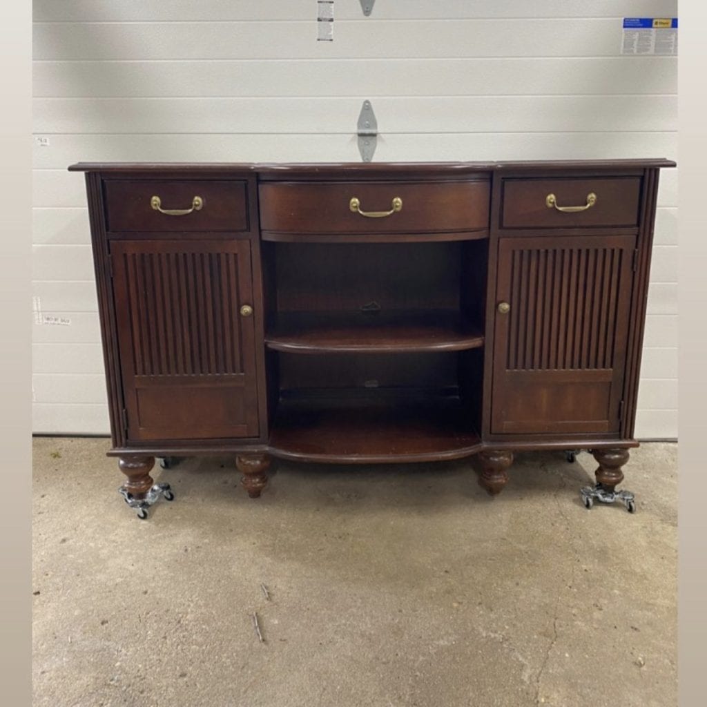 Before photo of wood buffet with three drawers, two cabinets and open shelving.