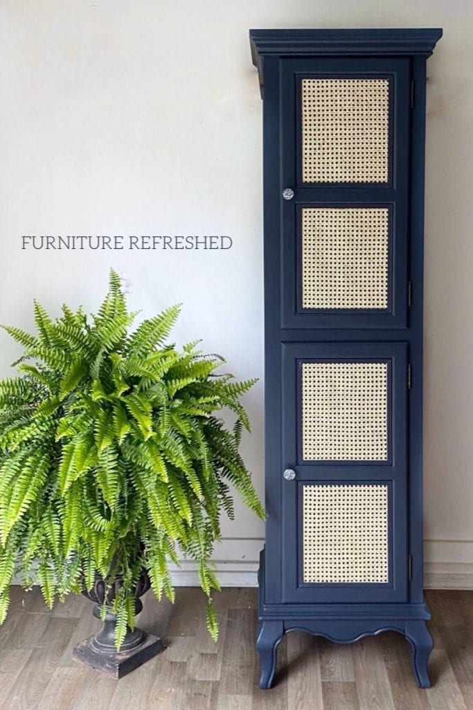 Before photo of a tall 2 door cabinet painted blue with cane webbing on the door fronts.