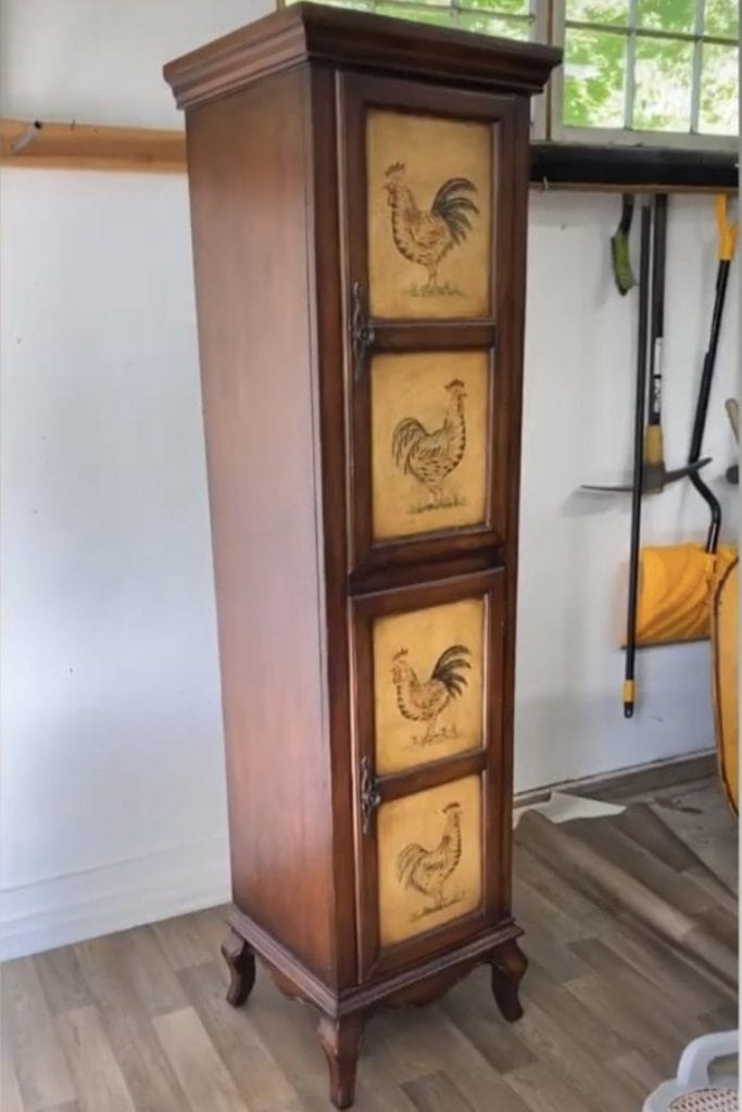 Before photo of a tall 2 door cabinet with countrystyle chickens on the door fronts.