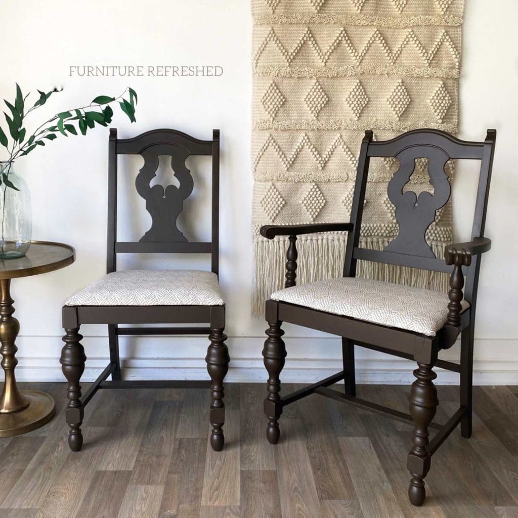 Photo of brown dining room chairs with white and brown upholstery on seats.