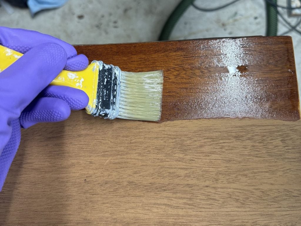 Applying shellac to a mahogany top with a chip brush.