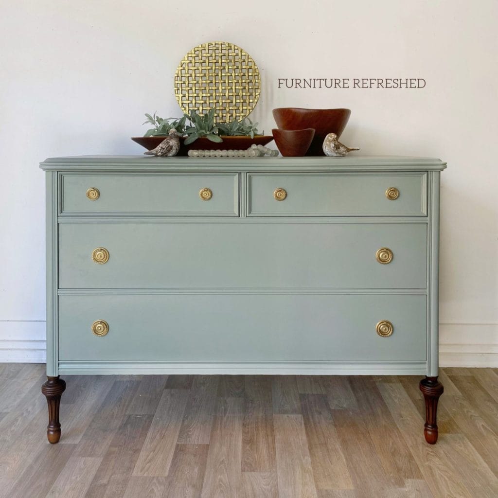After photo of dresser painted in a light blue/green color.