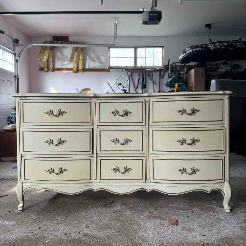 Before photo of French Provincial lowboy dresser with a white and gold finish.
