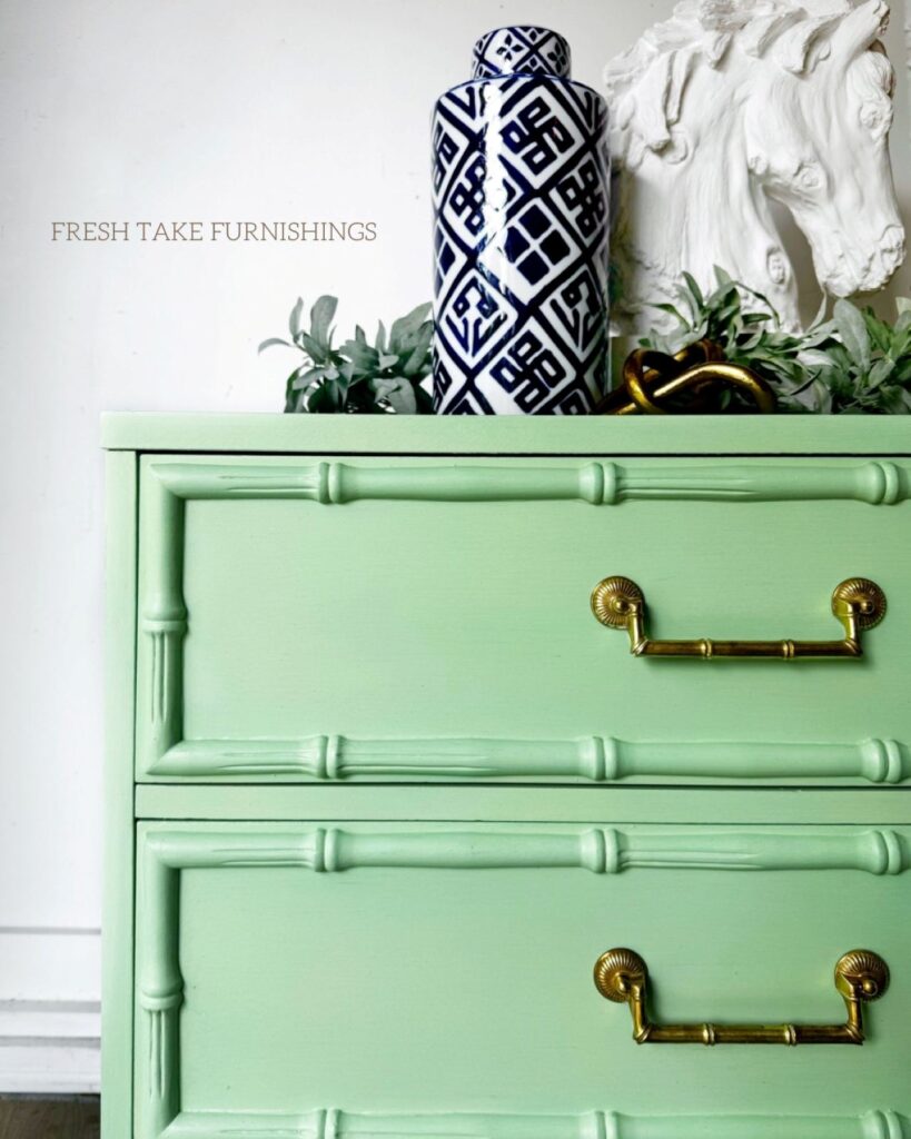 Close up of top left corner of faux bamboo green dresser.