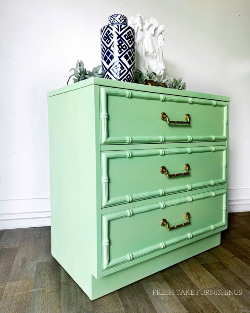 Angled side after photo of faux bamboo dresser painted in bright green.
