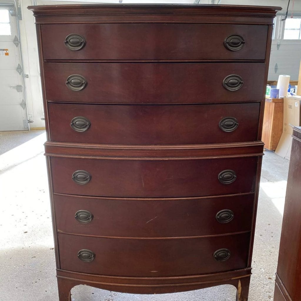 Before photo of Hepplehwite tallboy dresser with a dark brown stain.