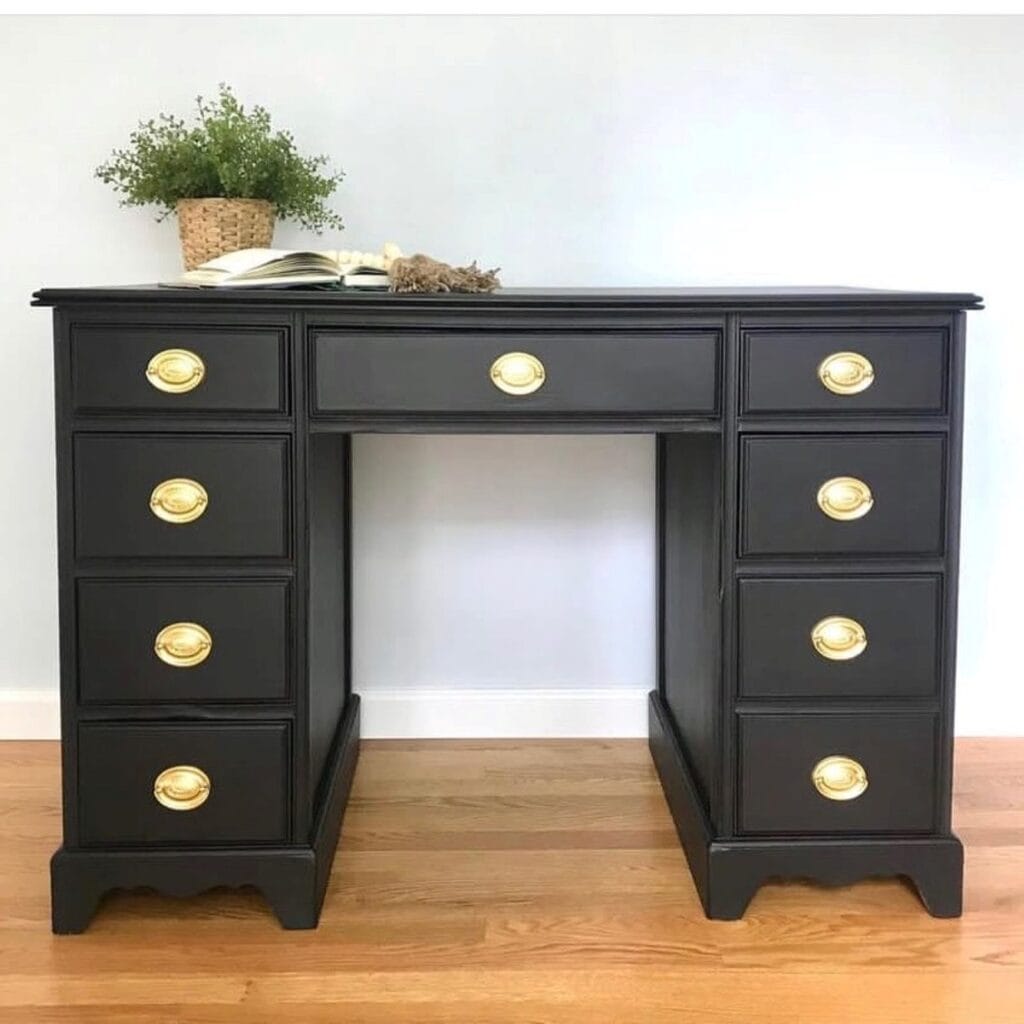After photo of wood desk painted black with gold Hepplewhite style hardware.