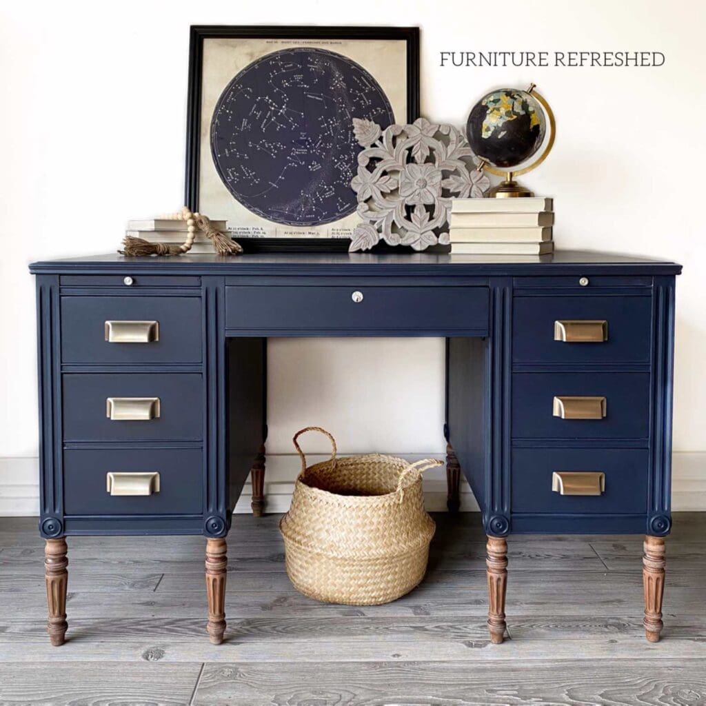 After photo of large wooden desk painted navy.