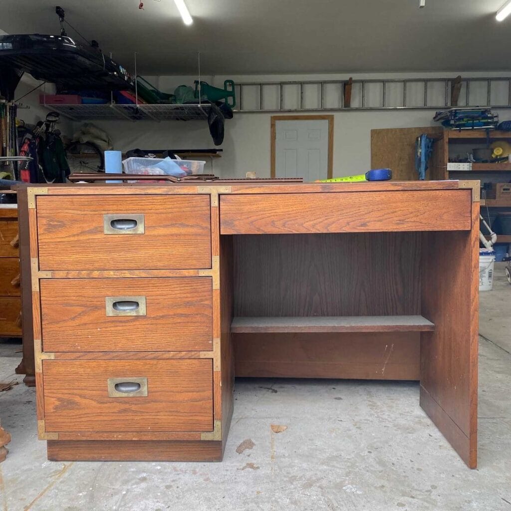 Before photo of wood Campaign style desk.