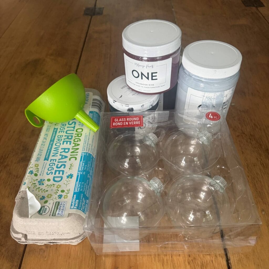 Supplies needs for this painted ornament project - paint, glass ornaments, a funnel and an egg crate.