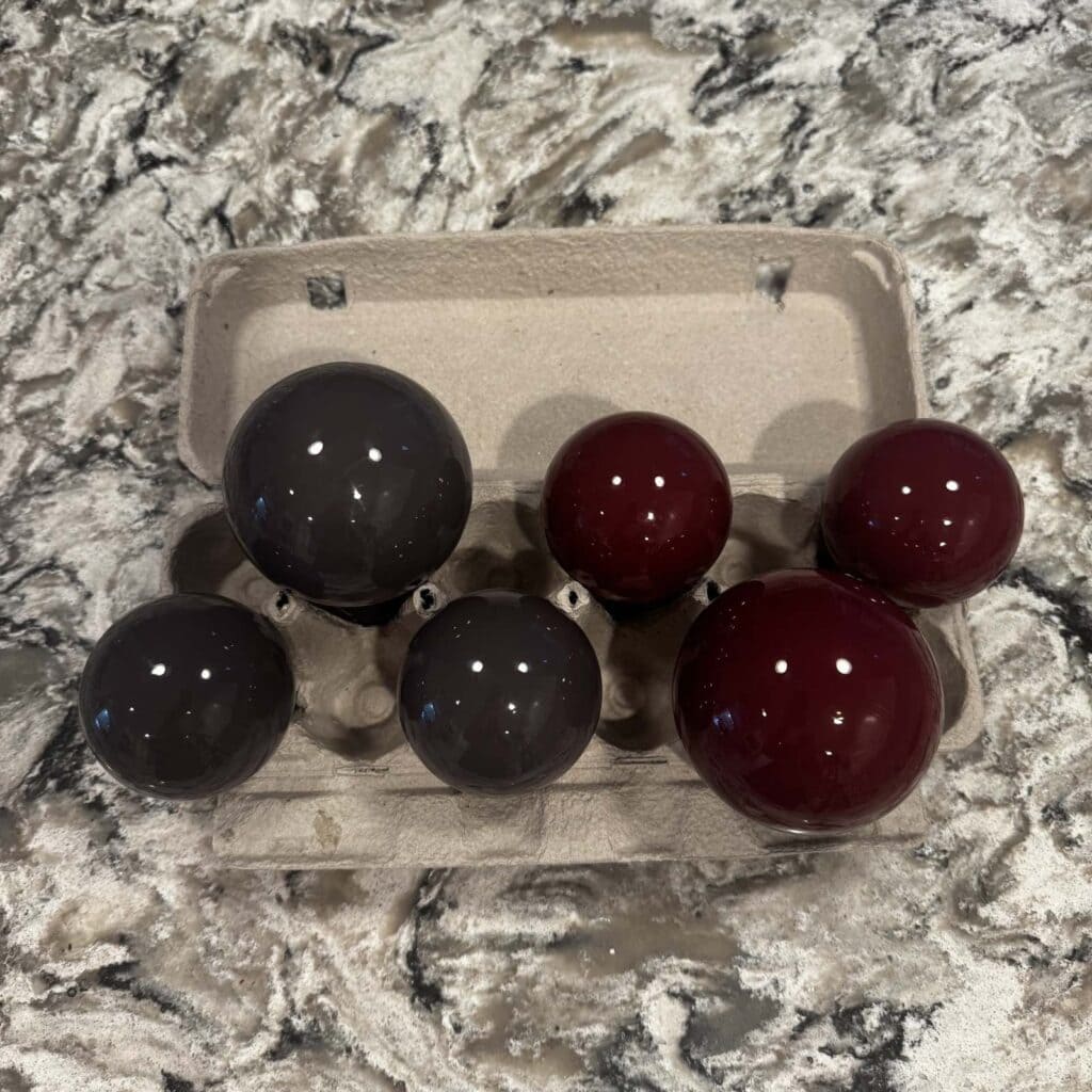 Ornaments turned upside down in an egg carton to dry