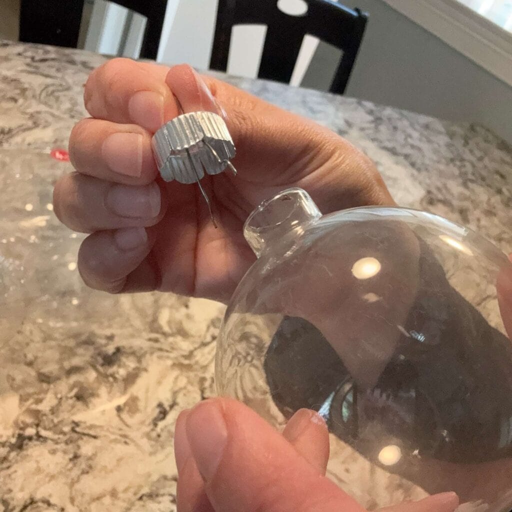 removing the hanging part of the ornament from the glass ball.