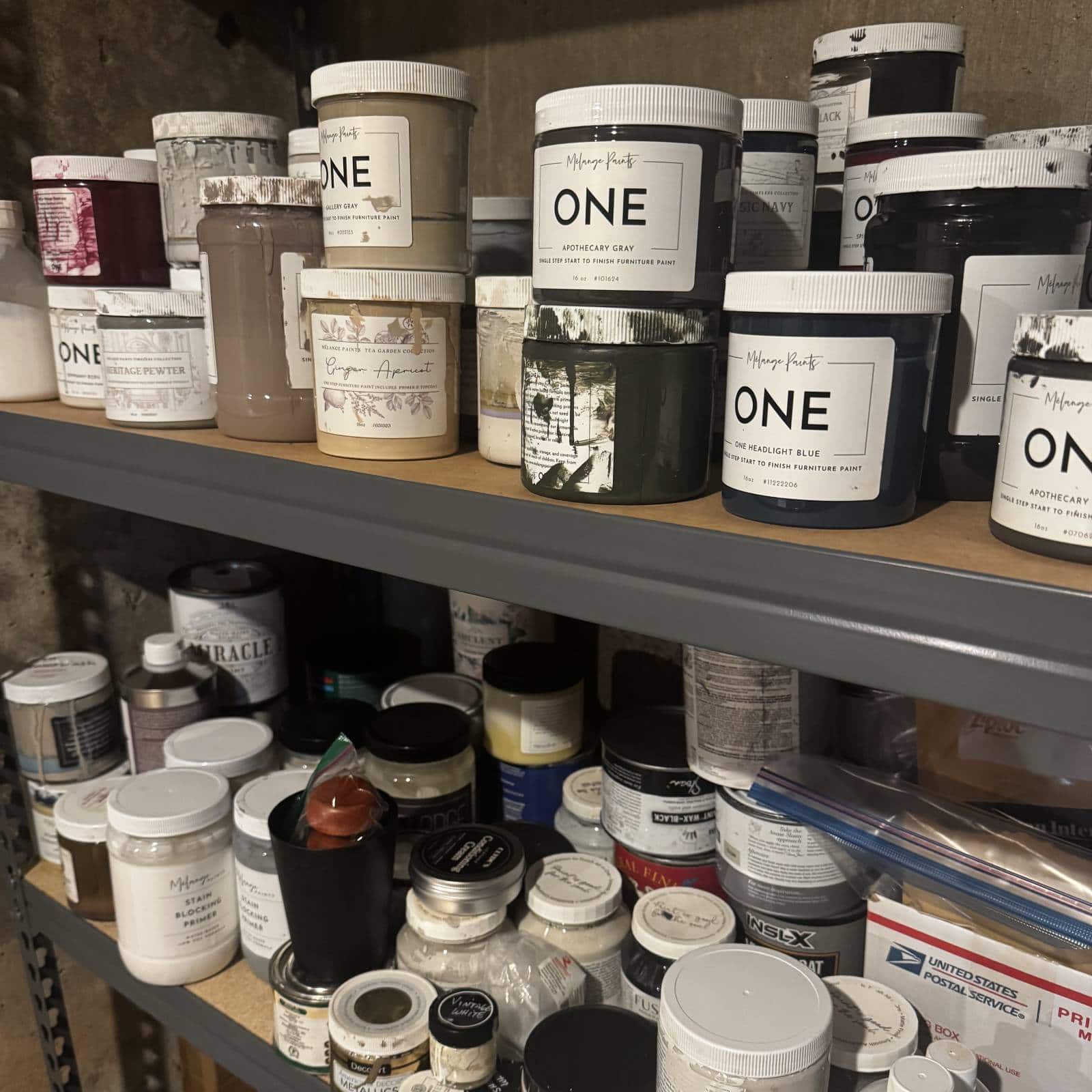 shelf of partially used furniture paint jars.