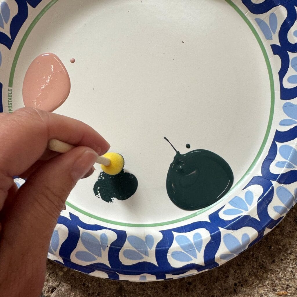 Applying paint to foam brush and blotting off the excess.