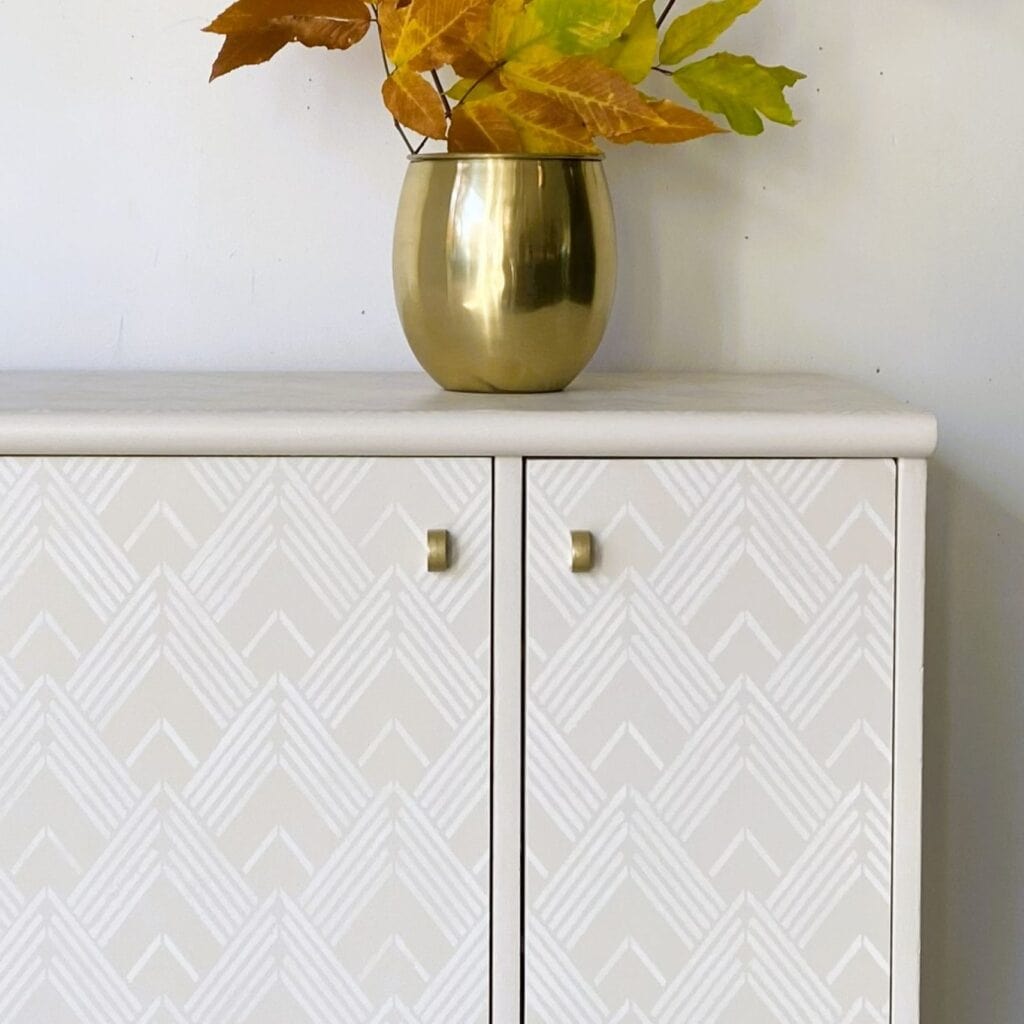 Close up of white stenciled cabinet